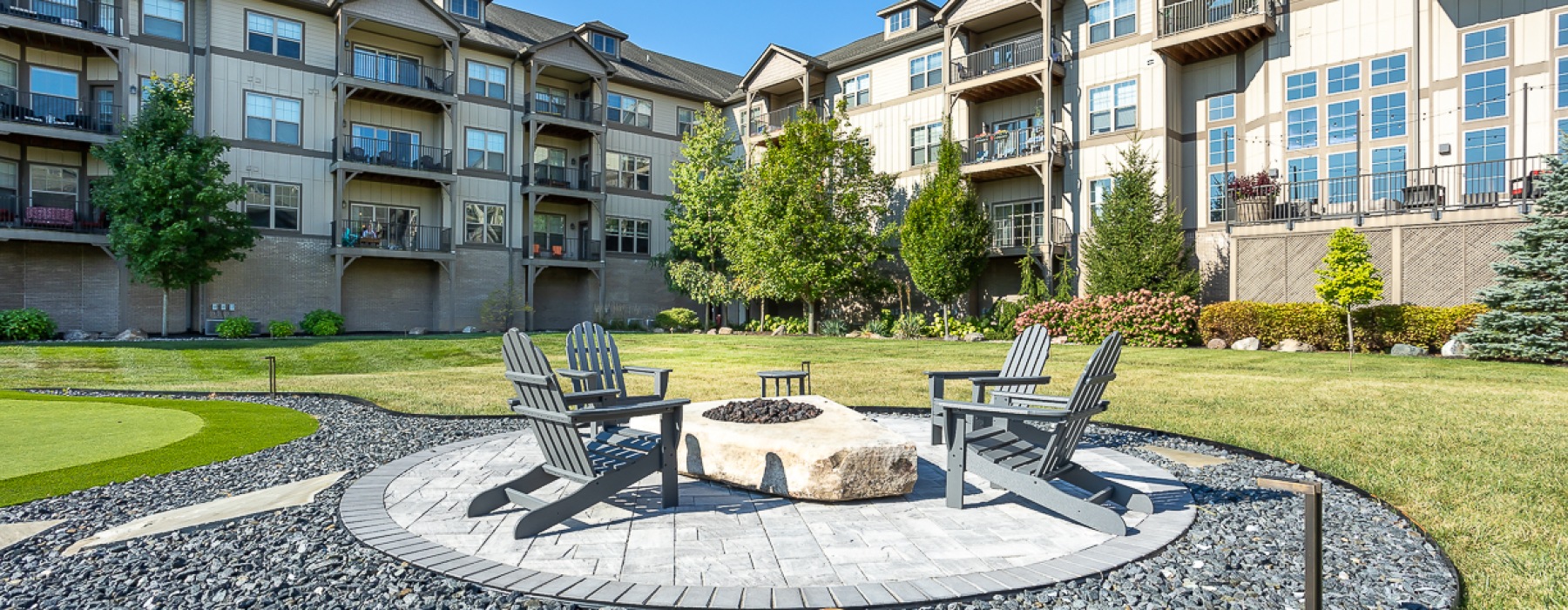 Firepit with chairs on round gravel patio