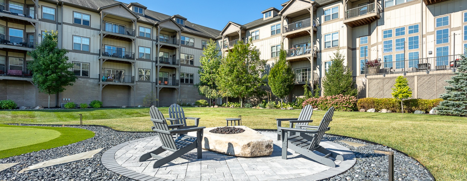 Firepit with chairs on round gravel patio